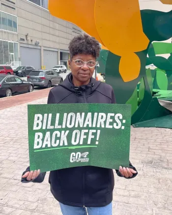 Sign reads "Billionaires: Back Off"